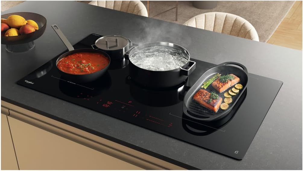 Whirlpool WEX9024DCFF2 induction hob in active use, with multiple pots and pans cooking on different zones, displaying digital timers and power levels.