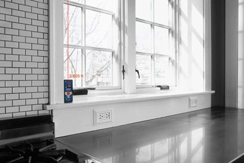 Bosch GLM 42 BLAZE Laser Measure showing laser dot on a wall