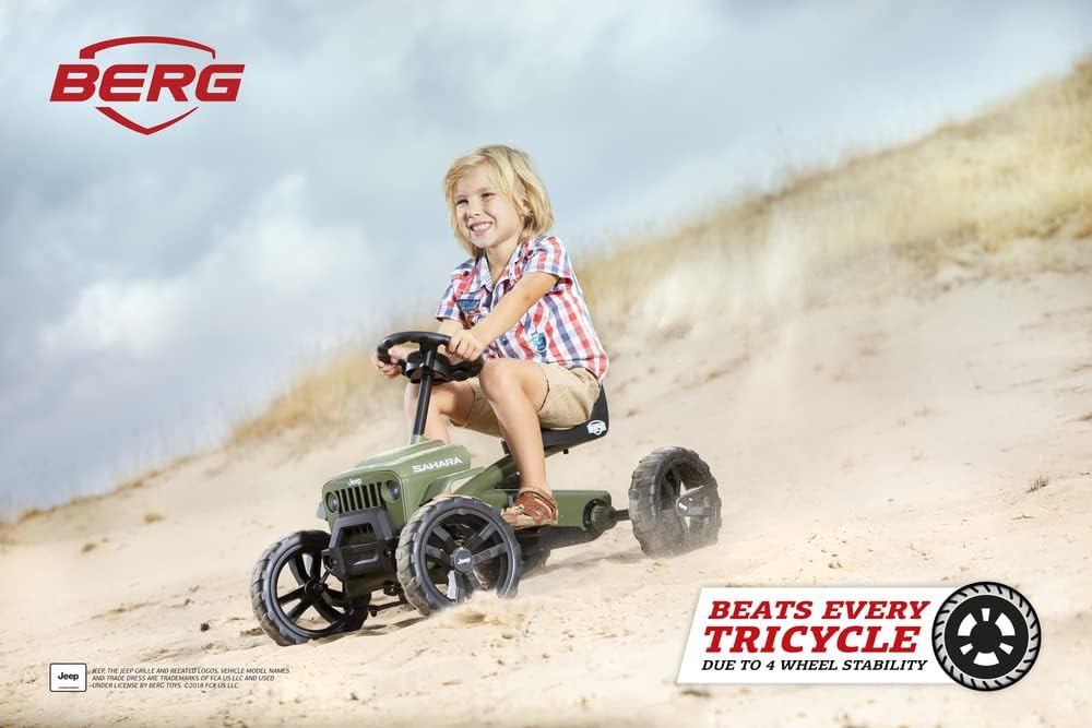 Child happily riding the BERG Pedal Kart Buzzy Jeep Sahara outdoors