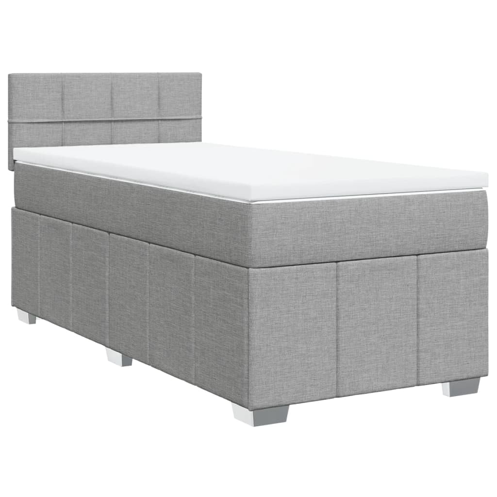 Łóżko kontynentalne 90 x 200 cm, jasnoszare z materacem ze sprężynami kieszeniowymi, miękkim obiciem z materiału, komfortowym topperem i oświetleniem LED do sypialni