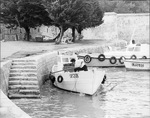 Vintage photo of Alain Delon travelling through boat.