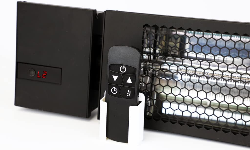 Close-up of the KING RK2430-RMT-BLK heater's control panel showing a digital display and a remote control in its wall holder.
