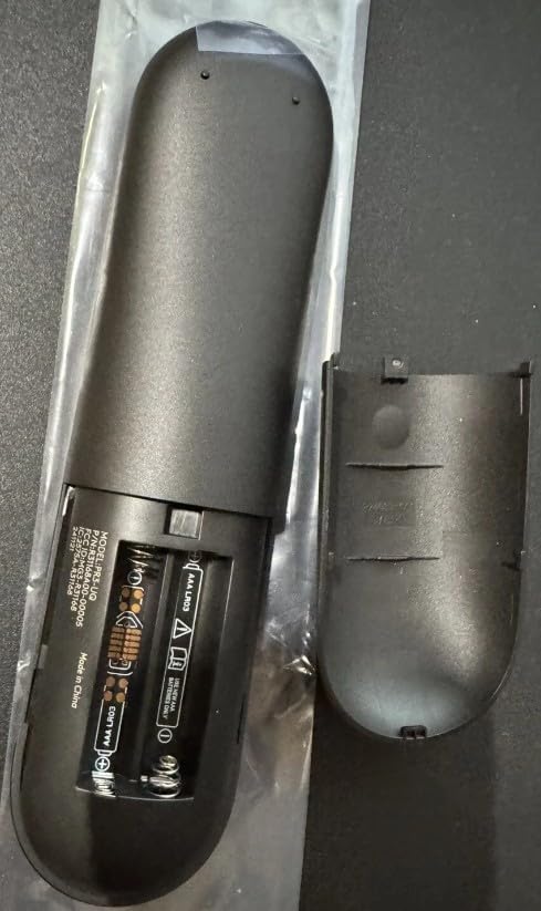 Back view of the XINFUTE PR3-UQ remote control with the battery cover removed, showing two AA batteries inserted into the compartment.