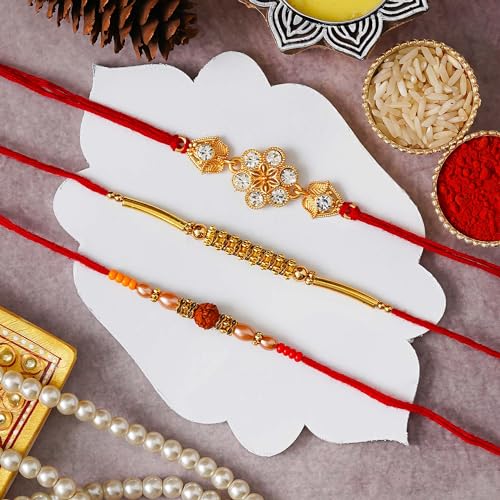 Image of eCraftIndia Red & Golden Set of 3 Trishul with Damru, Lord Ganesha, & Lord Krishna Playing Flute Religious Rakhis with Roli Chawal Pack