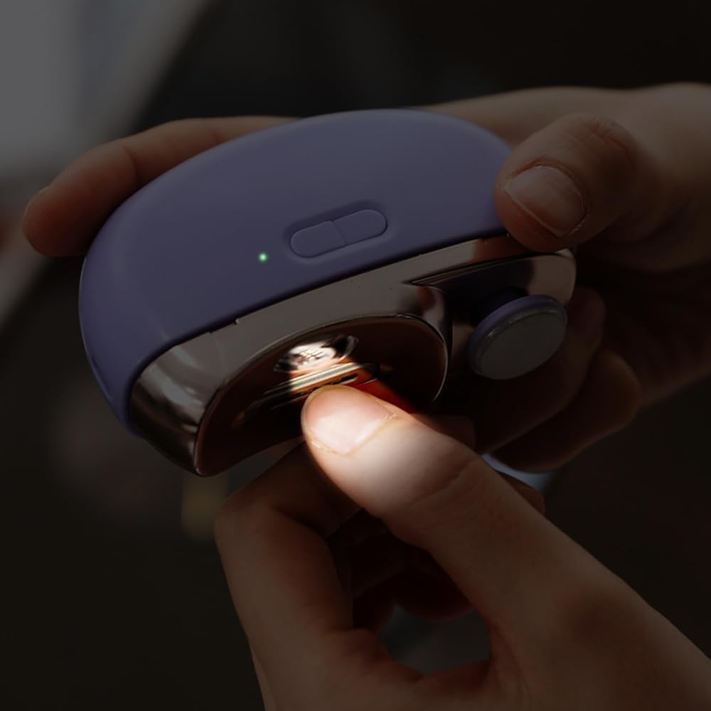 A finger being inserted into the trimming slot of the electric nail clipper, with the LED light illuminated.