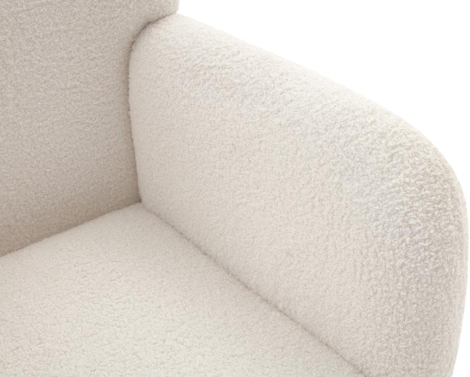 Close-up of the white bouclé fabric texture on the armchair's armrest
