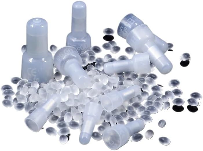 Multiple ROUPWKWO CE-1 closed end cap wire connectors scattered among small plastic pellets.