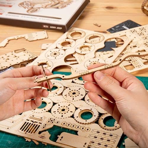 Hands assembling a small wooden piece from the 3D puzzle kit