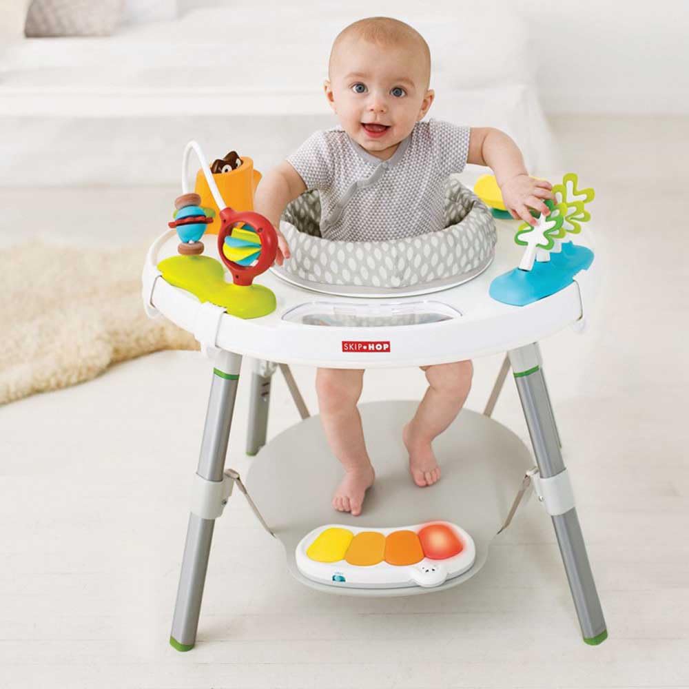 Skip Hop - Mesa de actividades escalable y rebote - Bebé de 4 meses y más - Juego de despertar para aprender a caminar - Asiento giratorio 360° rebotando + 25 actividades - Hebillas para atar juguetes