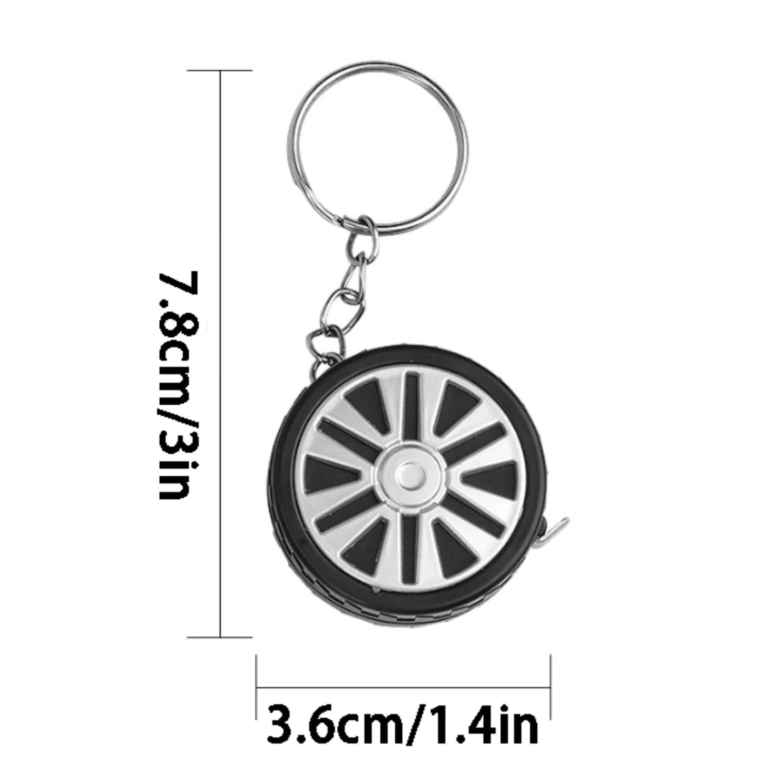 Cinta métrica compacta graduada con llavero y escala en pulgadas/métricos.