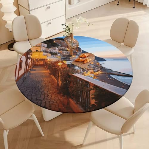 Table à manger protégée avec la nappe ronde Positano lavable pour cuisine