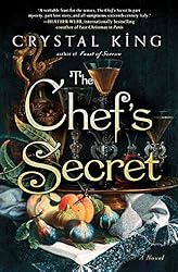 Book cover of The Chefs Secret with a glass of wine on a tray surrounded by fruits and vegetables. 