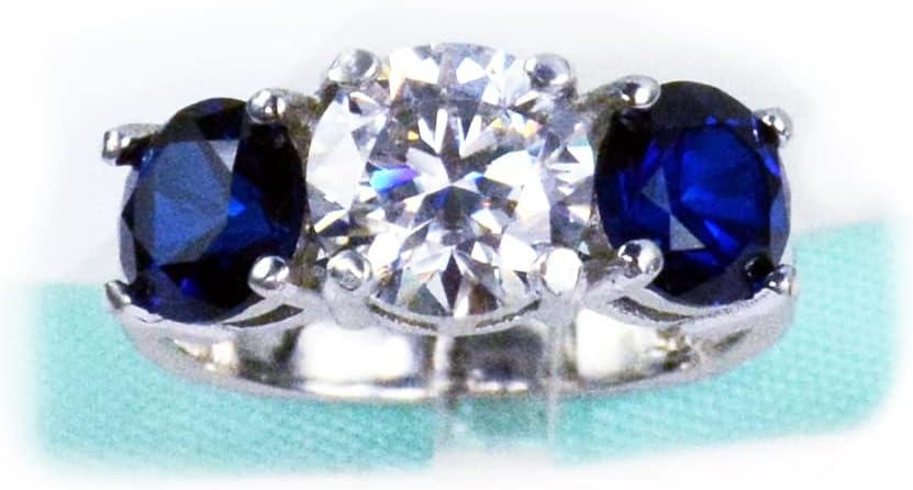 Three Stone Moissanite Ring with blue sapphire accents