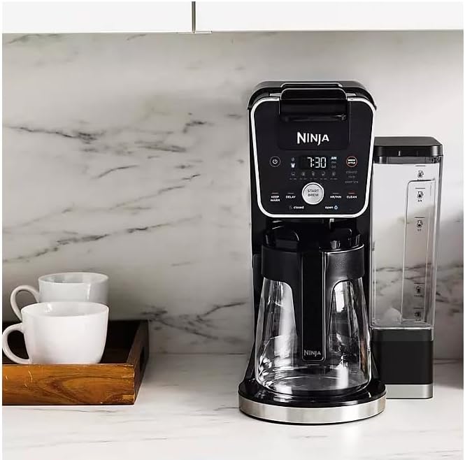 All components of the Ninja DualBrew PRO XL coffee maker, including the main unit, glass carafe, water reservoir, pod adapter, brew basket, and scoop.