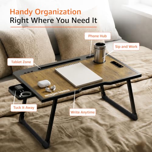 Image of Amazon Basics Engineered Wood Foldable Laptop Table with Cup and Pen Holder, Tablet and Mobile Phone Groove | Mini Drawer, Use for Writing, Bed, Breakfast (60L x 40W x 25H cm, Brown)