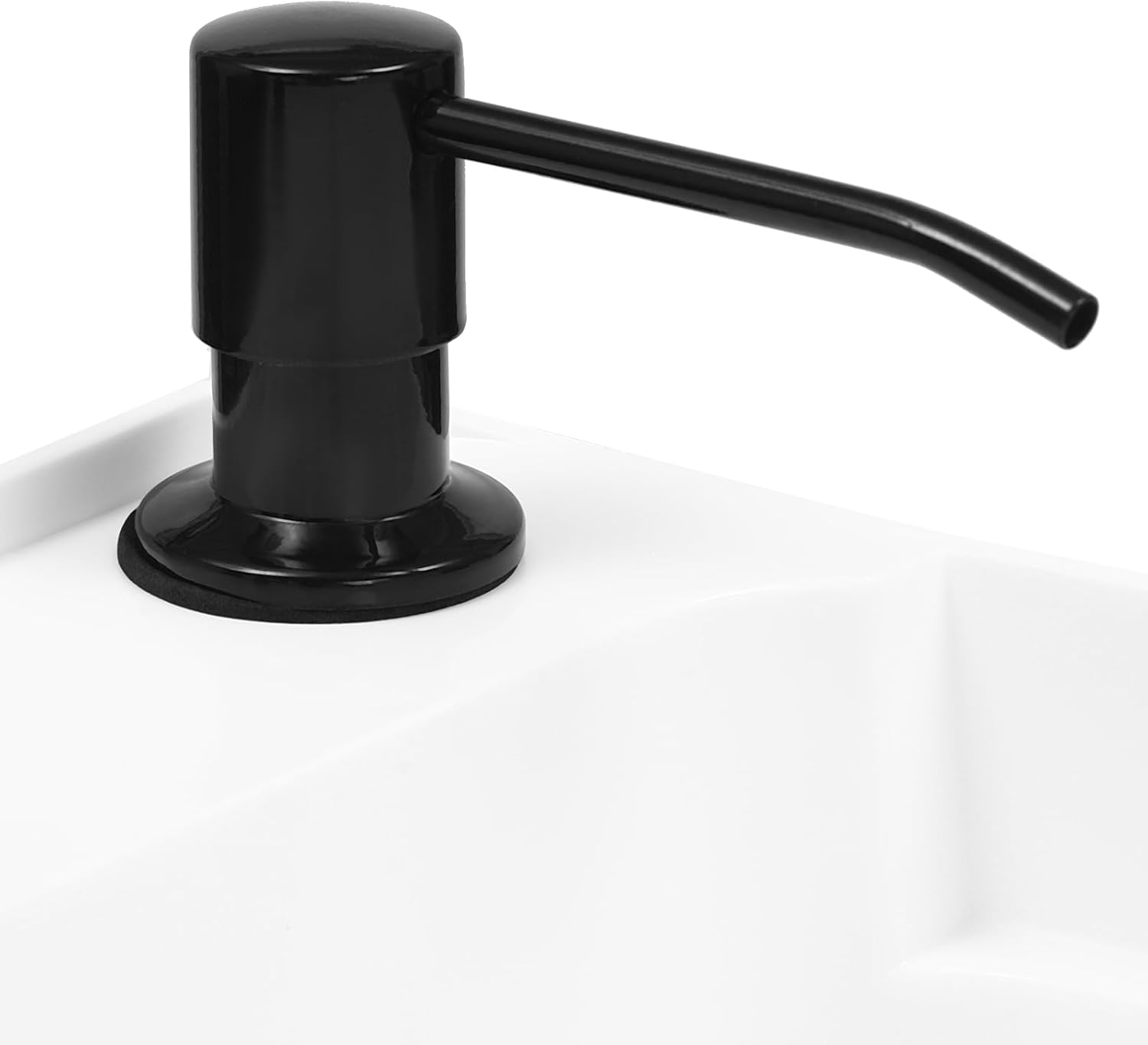 Close-up of the black soap dispenser on the white sink basin.