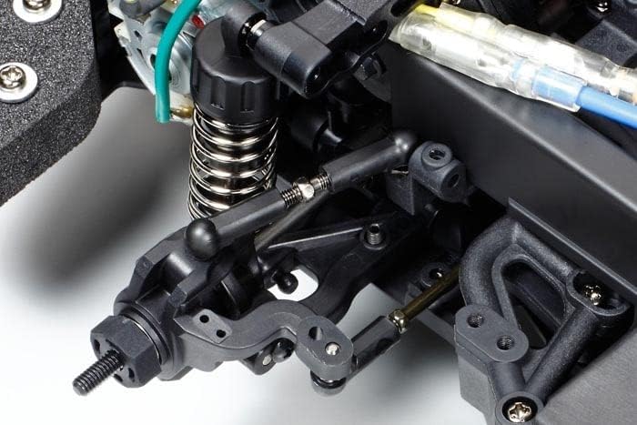 Close-up of the front steering and suspension components of the Tamiya XV-01 chassis, including tie rods and shock absorbers.