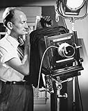 Side profile of a photographer adjusting a camera Poster Print (24 x 36)
