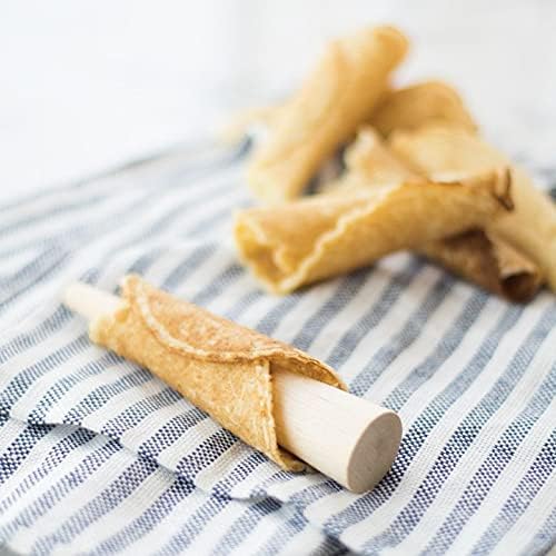 A krumkake cookie being rolled around the wooden cone