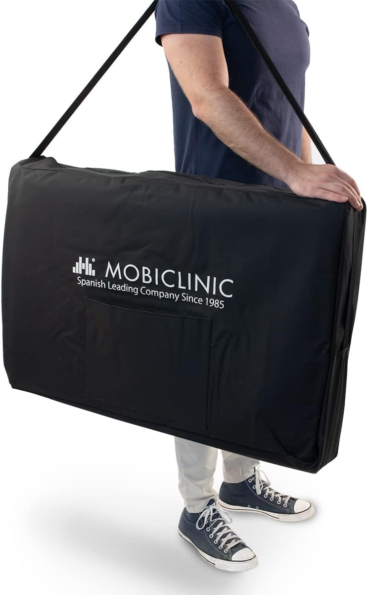 Person carrying the Mobiclinic Foldable Massage Table in its black carry bag