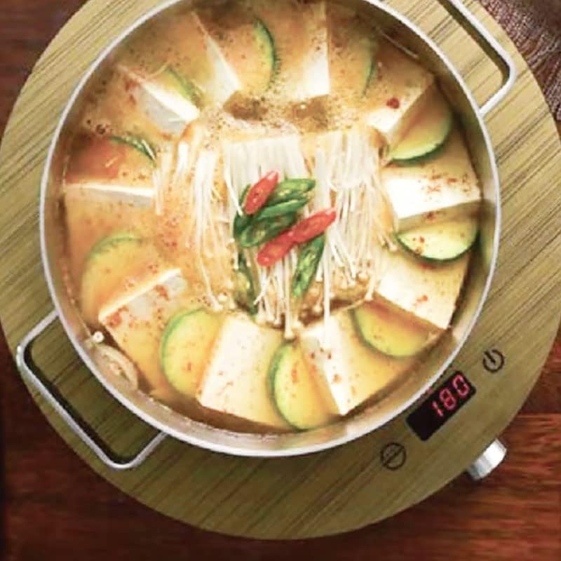 Top-down view of induction cooktop with a pot, showing digital display