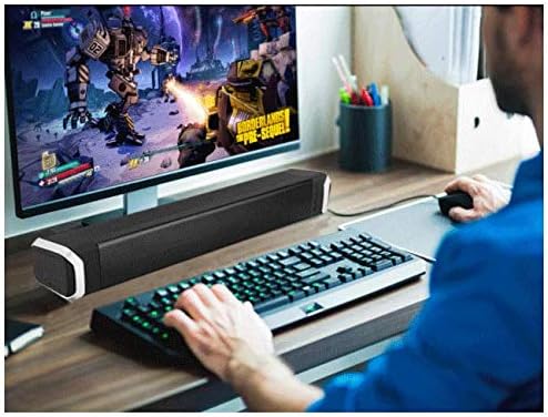 Newrixing NR-2017 Soundbar on a desk next to a computer monitor, used for gaming or multimedia.
