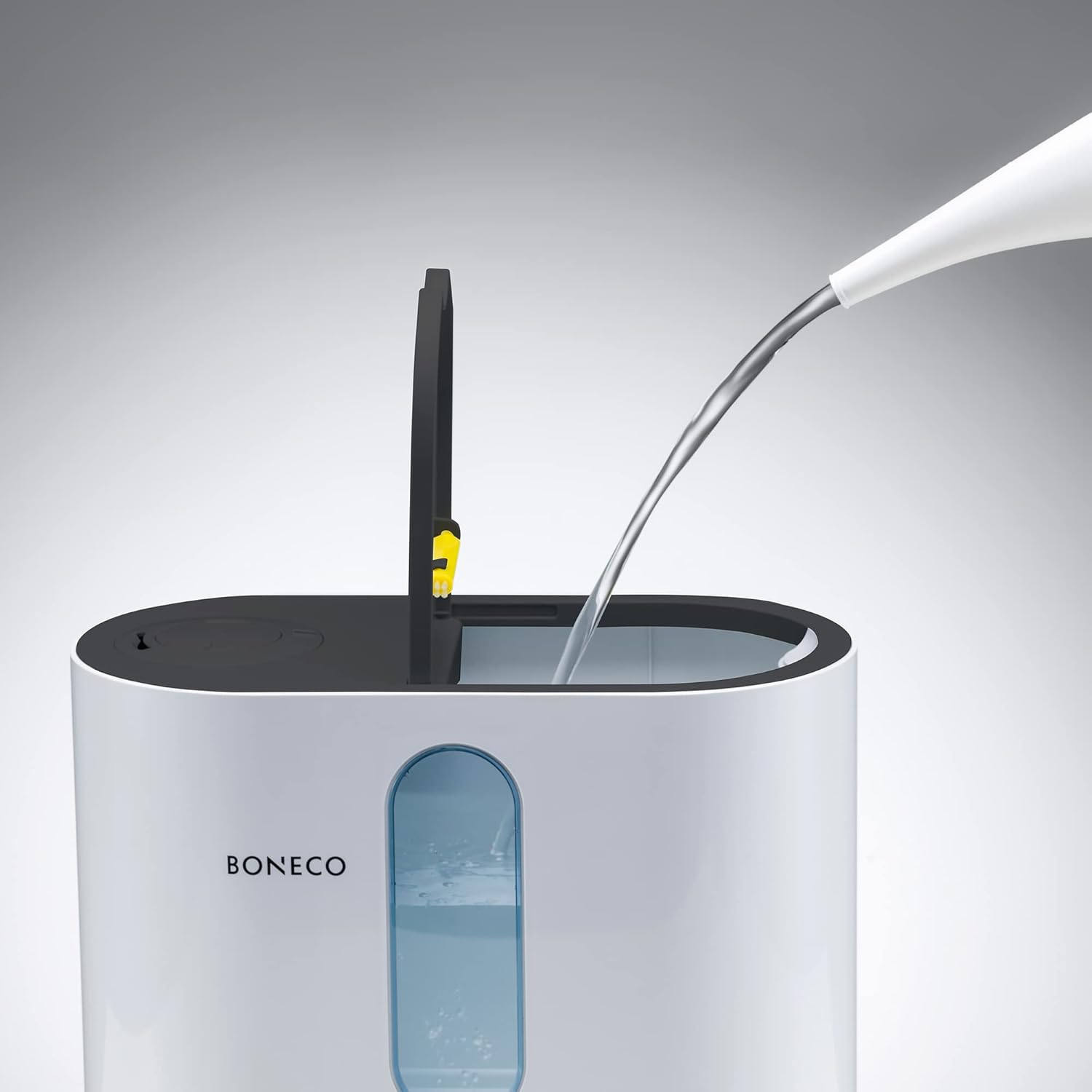 Hand pouring water into the top-fill opening of the BONECO U310 Humidifier.