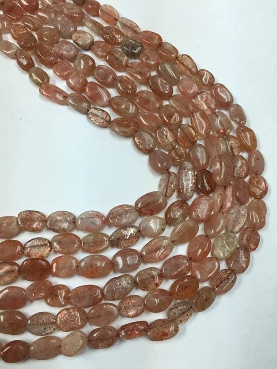 Pierre de soleil et quartz rouge en perles ovales pour bijoux chargés d'histoire