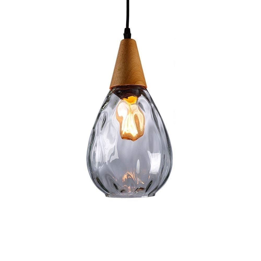 Lustre en verre transparent pour créer une ambiance chaleureuse au-dessus de la table du repas
