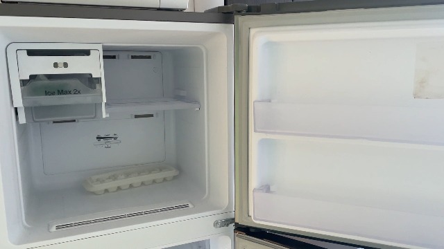 Showing off our new fridge with ice maker. Cool and efficient!