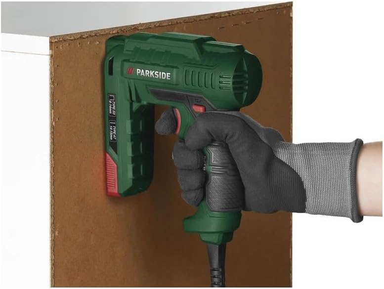 A person using the PARKSIDE PHET 15 C2 Electric Stapler to fasten a board to a wooden structure.