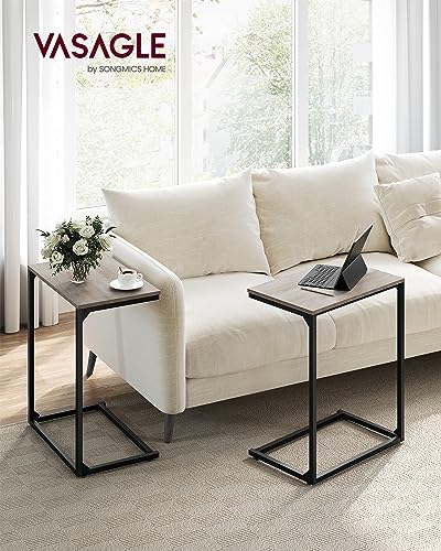 Greige and black C-shaped end table for a small seating corner