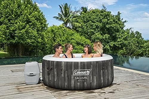 Four people enjoying the Coleman SaluSpa hot tub outdoors