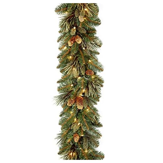 21+ Cozy Fireplace Christmas Decoration Ideas to Transform Your Home 2 National Tree Company Pre-Lit Artificial Christmas Garland, Green, Carolina Pine, White Lights, Decorated with Pine Cones, Plug In, Christmas Collection, 9 Feet