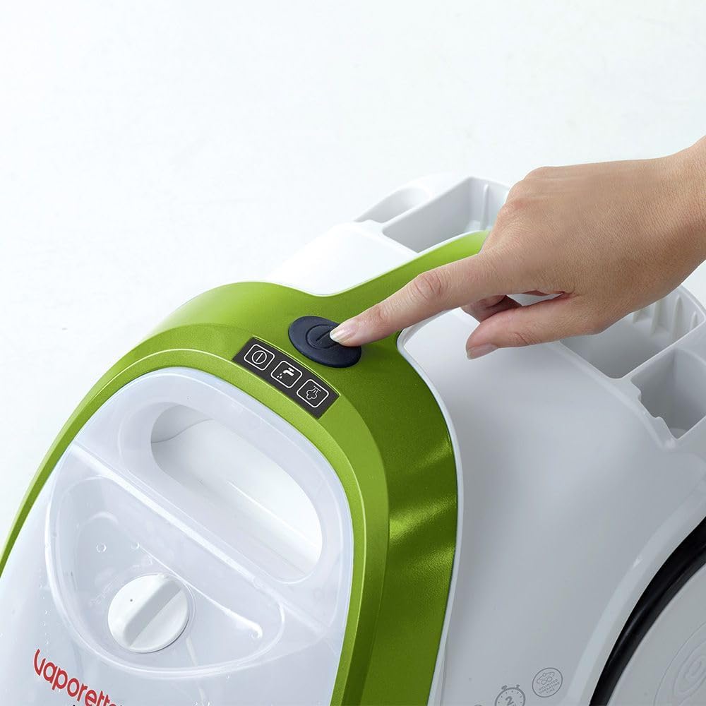 Hand pressing the power button on the Polti Smart 110 Eco