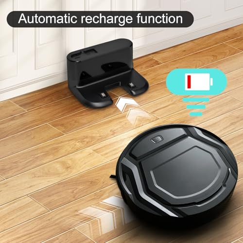 Black robot vacuum moving toward its charging dock on a wooden floor with an automatic recharge message and battery symbol.