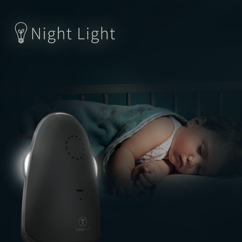 TimeFlys Baby Unit with its night light illuminated in a dark room where a baby is sleeping.