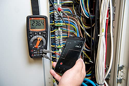 Sonel CMM 30 Multimeter connected to an electrical panel, with a smartphone displaying the measurement reading remotely.