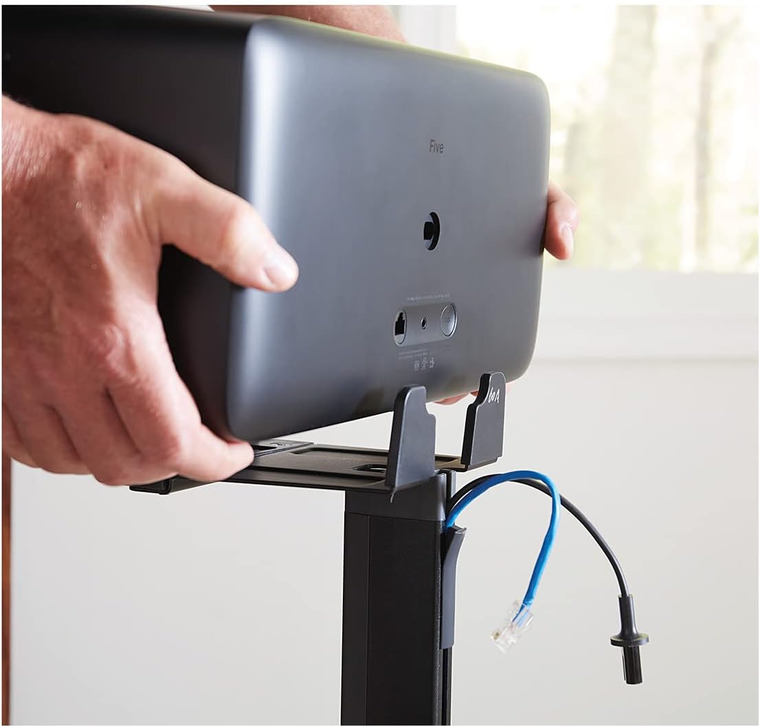 Hands placing a Sonos Five speaker onto the stand's bracket