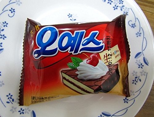 A single individually wrapped Haitai Oh Yes! Chocolate Coated Cake on a white plate.