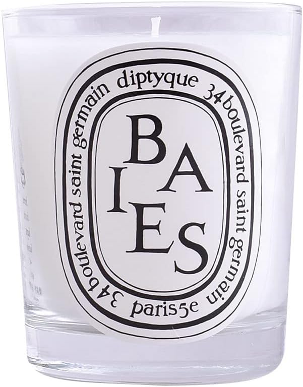 A high-quality, fragrant Diptyque candle in a glass jar.