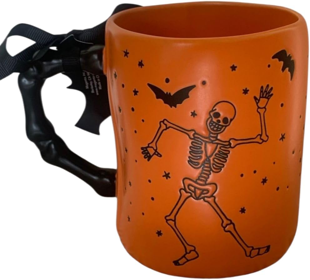 Rae Dunn Trick or treat Halloween Ceramic coffee mug with Dancing skeleton and bat detail. Orange mug