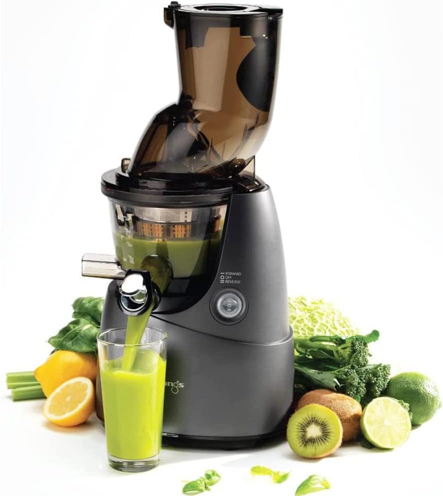 Kuvings B9700 Slow Juicer actively extracting green juice into a glass