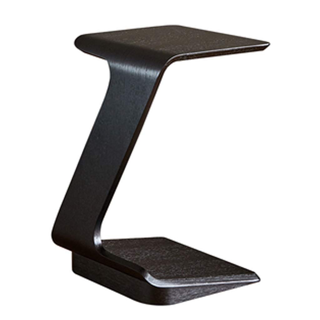 Mesa de madera maciza para revistas junto al sofá y mesita de noche negra