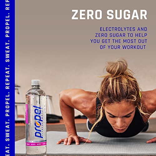 A woman in a black sports bra and black leggings is doing push-ups on a blue mat. She has her hands shoulder-width apart and her legs extended behind her. She is looking down at the ground. There is a Propel Fitness Water bottle on the ground next to her. The bottle is blue and white and has a black cap. The bottle is labeled 'Propel Fitness Water' and has a picture of a runner on the front.