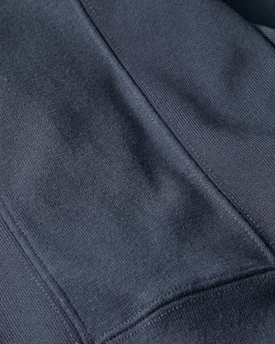 Top-down view of a smartphone charging wirelessly on the base of a multi-functional desk lamp.