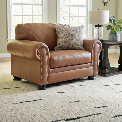 Image of Signature Design by Ashley Carianna Oversized Leather Accent Chair, Caramel | Top-grain leather seating, Durable faux leather outer panels, Extra-wide 54 in frame, Traditional living room style