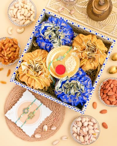 Image of Hyperfoods Rakhi for Brother with Dry Fruits Rawfruit's Handcrafted Potli Blue And Red with Thali Roli & Chawal Rakhi Gift Hamper for Brother Pack of 4 Cashew Almond Pistachios Raisins 495gm With Set of 3 Meena Rakhi