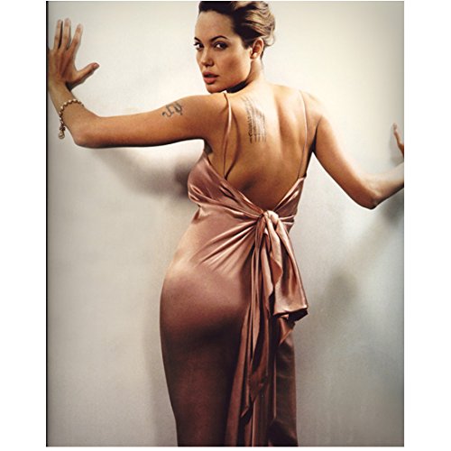 angelina jolie pink dress Angelina Jolie Backside View Wearing Pink Satin Dress Low Cut Back Tied in  Back Head Turned Looking Back Hands on Wall Mouth Parted 8 X 10 Inch Photo  at Amazon's Entertainment Collectibles Store