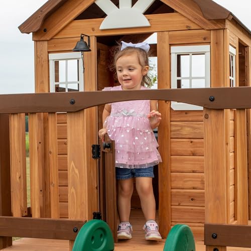 Image of Backyard Discovery Echo Heights Elevated Cedar Wooden Kids Playhouse with Wave Slide, Play Kitchen, Wrap-Around Deck, Flat-Step Ladder, Half Door, Windows, Bell, and Growth Chart for Outdoor Play